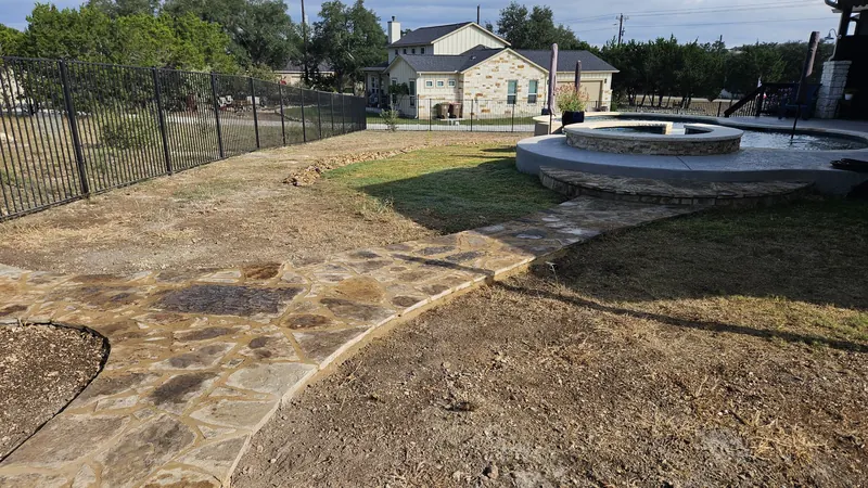 Flagstone path to a stone fire pit in Spring Branch, TX by CJK Landscaping